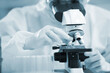 © sittinan - Laboratory research. Team work Scientists  study data and evaluating microscope success. they are doing research with dropper chemical testing life science and find vaccine for covid 19