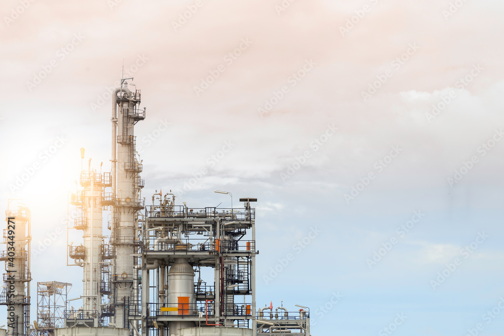 Industrial of oil refinery plant from industry zone ,Refinery factory oil storage tank and pipeline steel with sunset sky.