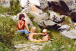 Vintage colorful 1977 image of a young mother with son and daughter having a picnic on the Monte Moro Pass on the border of Italy and Switzerland.	
