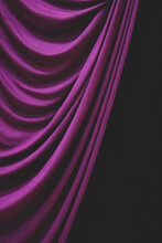 Detail Draped Purple Curtain Against Black Background