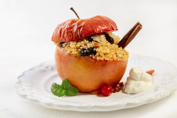 Wall Mural - Baked apple with couscous, raisins and walnuts.