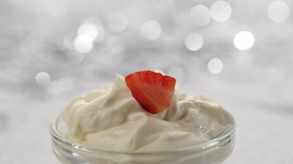 Canvas Print - pieces of strawberries fall in whipped mascarpone cream on a silver bokeh festive background