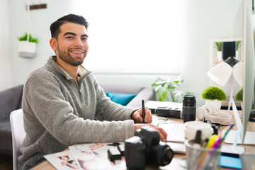 Wall Mural - Portrait of a smiling latin man working as a photographer