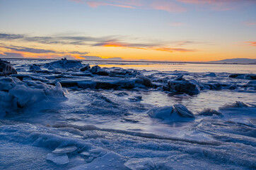 Poster - Sunset over the ocean and cracked ice field, on a winter day in Iceland.