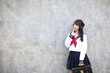 © Oran Tantapakul - Portrait of Asian schoolgirl with grey background
