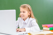 © Ermolaev Alexandr - Happy young girl studies with laptop in a school