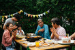 © THESHOTS.CO - Asian family celebrate birthday party for a kid with cake at yard.