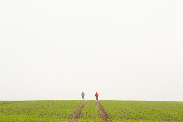 Couple of farmers inspect the field during autumn season