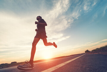 Wall Mural - Athlete runner feet running on road, Jogging concept at outdoors. Man running for exercise.