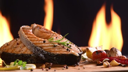 Wall Mural - Grilled salmon fish with various vegetables on pan on the flaming grill