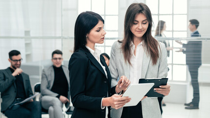 Wall Mural - two business women discussing business documents in the office