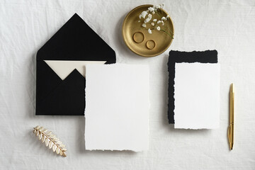 Wall Mural - Handmade paper invitation cards or wedding stationery mockup with card and envelope on bed. Minimal style. Flat lay, top view.