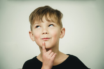 portrait of a dreaming and pensive boy on a white background close-up