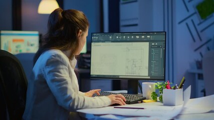 Wall Mural - woman architect matching digital plans from pc with blueprints working in start-up business office o