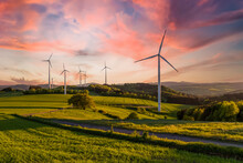 Wind Turbine In The Field At Sunset