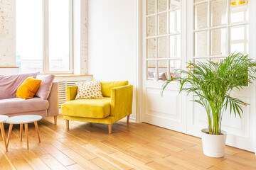 Scandinavian style apartment interior. bright yellow warm colors. wooden flooring. sunlight in large windows.