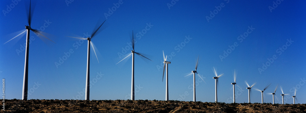 Photo of Spinning Wind Turbines - obrazy, fototapety, plakaty 