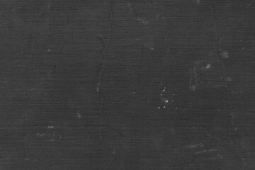 Cardboard black abstract texture close-up. Dark old paper background. Grunge concrete wall. Vintage blank wallpaper.