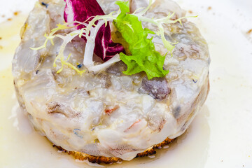 Wall Mural - Sea bass tartare with toasted bread on a white plate