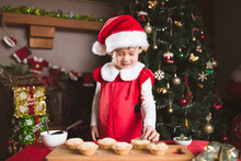 Young Girl Preparing Mince Pie For Celebrating  Christmas Party