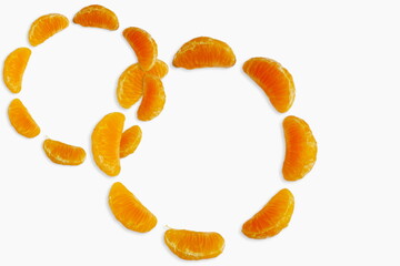 Wall Mural - fresh orange or tangerine citrus fruits segments circle frame isolated in white background