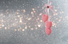 Three Pink Hearts Hang On A Ribbon On A Gray Glittery Background With Pink Delight