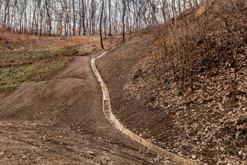 Concrete drainage ditch on hillside