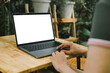 © panitan - computer screen blank mockup.hand woman work using laptop with white background for advertising,contact business search information on desk at coffee shop.marketing and creative design
