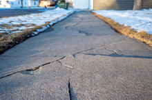 Frost Heave Crack In Residential Concrete Sidewalk