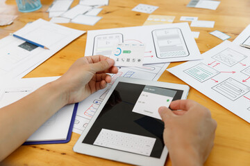 Graphic designers work together with UX UI designer planning application template layout framework for mobile phone computer mobile