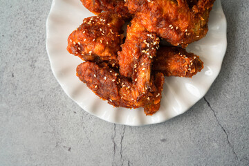 Deep fried chicken wing with hot and spicy sauce in Korean style or asian food concept.