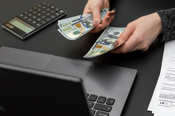 Businesswoman counting money at office workplace. Close up. Business concept.