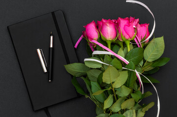 Wall Mural - Closed notepad with bouquet of roses.