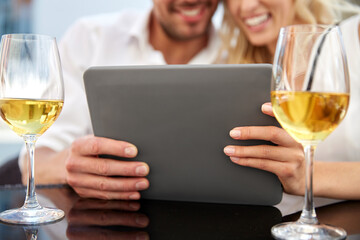 Poster - people, technology and dating concept - close up of happy couple with tablet pc computer and wine at restaurant