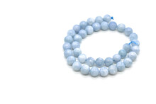 Aquamarine Bead Strand On White Background.  Copy Space Is On The Left Side. 