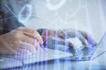 Double exposure of businesswoman hands typing on computer and forex chart hologram drawing. Financial analysis concept.