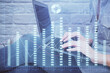 © peshkova - Multi exposure of woman hands typing on computer and forex chart hologram drawing. Stock market analysis concept.