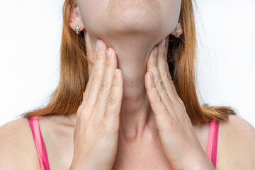 Wall Mural - Woman with throat sore is holding her aching throat