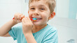 © Kyrylo Ryzhov - Funny toddler boy smiling and laughing while brushing and clening teeth with toothbrush in bathroom