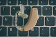 Hearing aid lying on a laptop