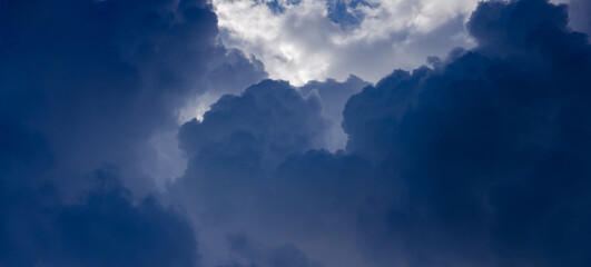 Wall Mural - Dramatic cloudscape. Sky background with dark gray cumulus clouds