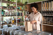 © Cavan Images - African American woman packing eco pasta in shop