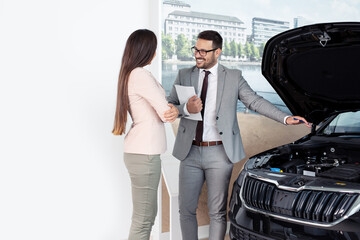 Wall Mural - Vehicle salesman presenting new cars at showroom