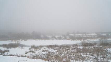 Wall Mural - landscape with fog in a winter field