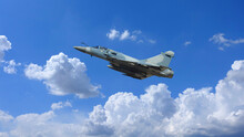 Ultra Zoom Photo Of Fighter Interceptor Plane Performing Extreme Stunts In Deep Blue Cloudy Sky