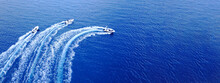 Aerial Drone Ultra Wide Top Down Photo Of Synchronised Powerboats Cruising In High Speed In Deep Blue Open Ocean Sea