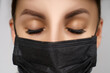 © Aliaksandr Barouski - Eyelash Extension Procedure. Beautiful Woman with Extreme Long False Eyelashes. Makeup, Cosmetics. Beauty, Skincare. Woman in medical mask.