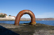 An old rusty metal device for mooring a boat on a sea pier. 