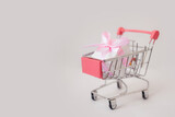 Fototapeta Mapy - Pink gift box in basket, holiday concept