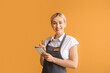 Young female waiter on color background